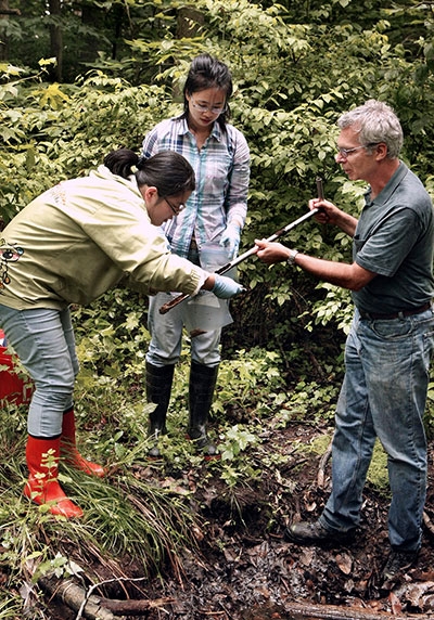 Professor Peter Jaffe (right) discovered a soil bacterium that could help clean contamination from groundwater. Here Jaffe and colleagues collect soil samples from the Assunpink Wildlife Management Area in New Jersey where the bacterium was originally discovered. (Photo by Frank Wojciechowski)