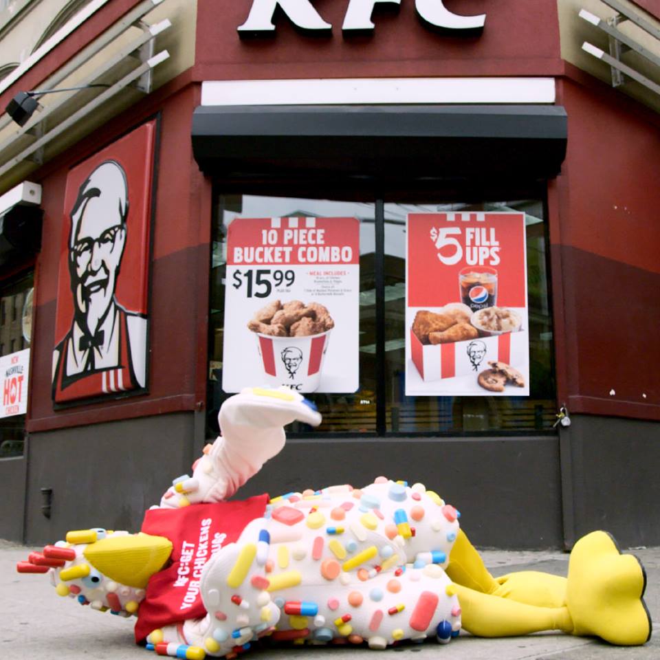 An NRDC activist uses a chicken costume to call attention to KFC's use of animals raised with antibiotics. (NRDC)